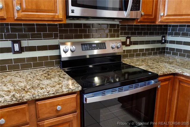 a kitchen with granite countertop a sink and a wooden cabinets