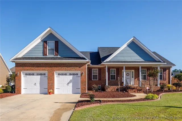a front view of a house with garden and porch