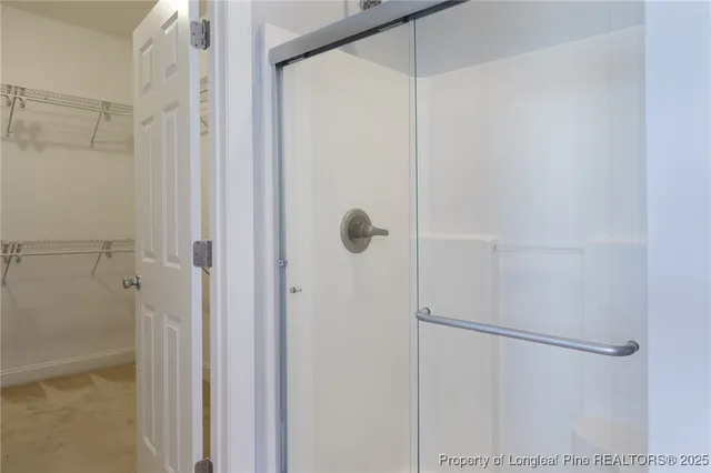 a view of walk in closet with empty racks