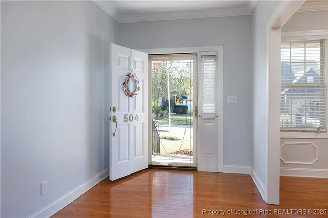 a view of an entryway with wooden floor and a window