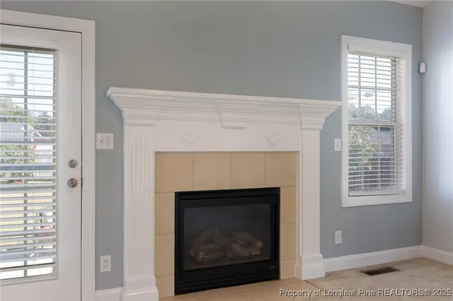 a living room with a fireplace and a window