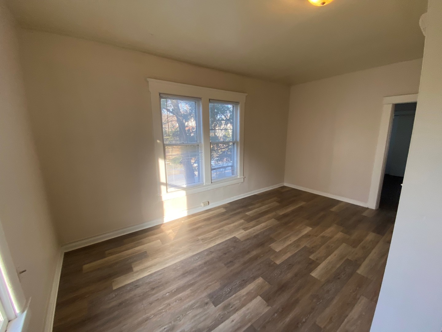 617 West Springfield Avenue Champaign, IL 61820 - Photo 7 of 10 an empty room with wooden floor and windows