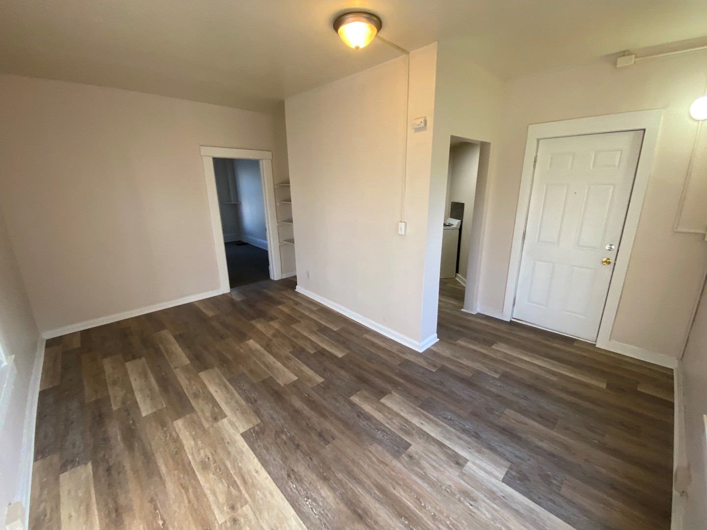 617 West Springfield Avenue Champaign, IL 61820 - Photo 8 of 10 a view of a big room with wooden floor and windows