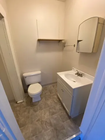 a bathroom with a sink a toilet and mirror