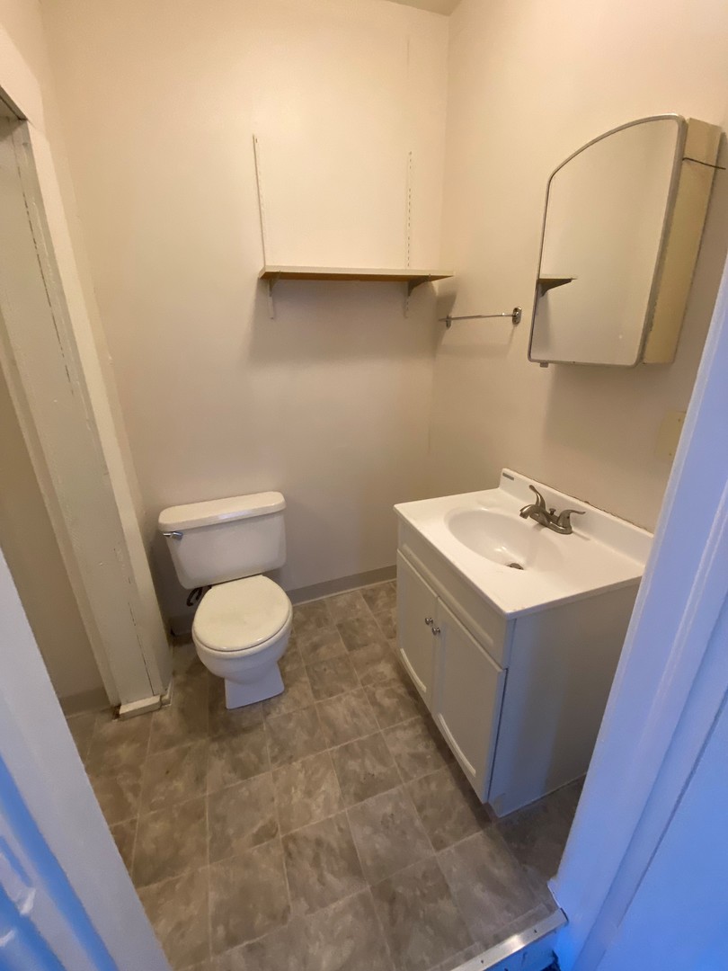 617 West Springfield Avenue Champaign, IL 61820 - Photo 9 of 10 a bathroom with a sink a toilet and mirror