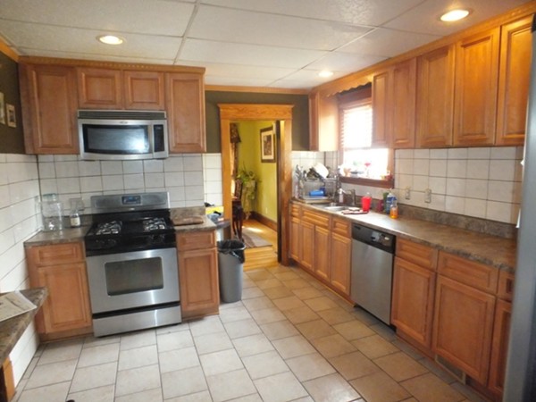 106 Stockman Street Springfield, MA 01104 - Photo 12 of 20 a kitchen with stainless steel appliances a stove a sink and a microwave