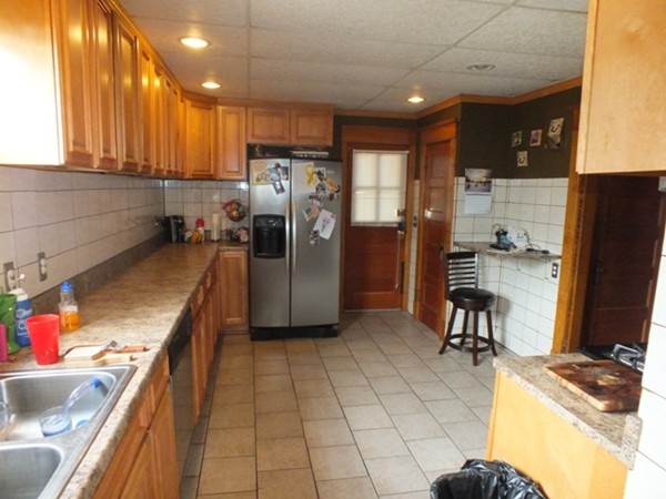 106 Stockman Street Springfield, MA 01104 - Photo 13 of 20 a kitchen with refrigerator and cabinets