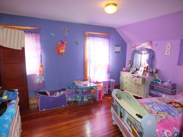 106 Stockman Street Springfield, MA 01104 - Photo 14 of 20 a bedroom with furniture and a wooden floor