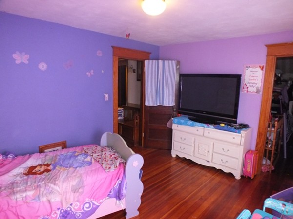106 Stockman Street Springfield, MA 01104 - Photo 15 of 20 a bedroom with a bed and a flat screen tv