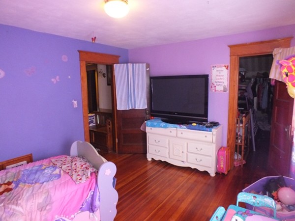 106 Stockman Street Springfield, MA 01104 - Photo 16 of 20 a bedroom with a bed and flat screen tv