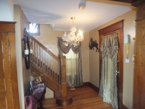 106 Stockman Street Springfield, MA 01104 - Photo 6 of 20 a view of a hallway with wooden floor and staircase