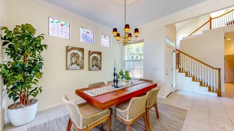 a dining room with furniture and window