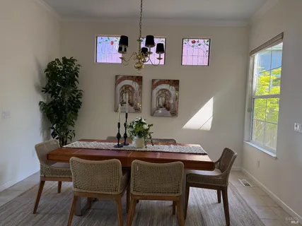 a dining room with furniture and window