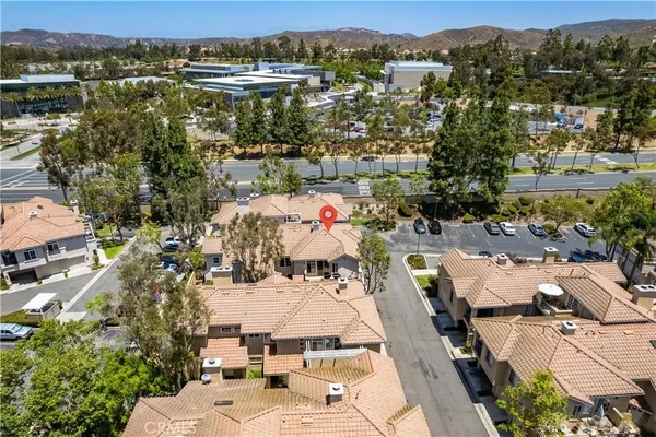 an aerial view of multiple houses with yard