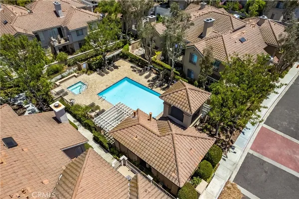 an aerial view of a house with a yard and furniture