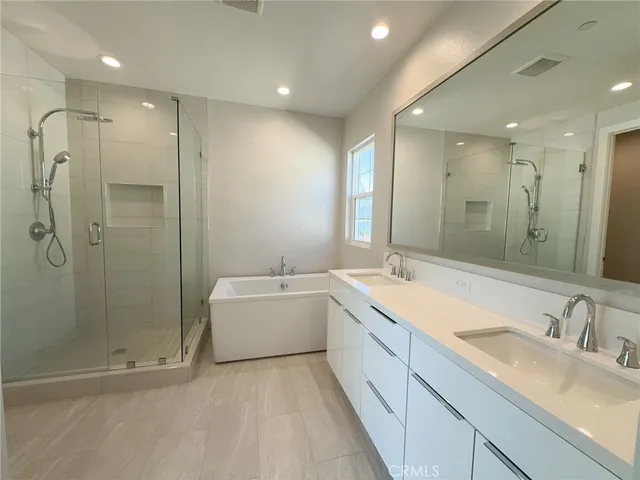 a bathroom with a double vanity sink mirror and shower