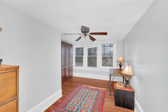 a front view of a house with wooden floor and a rug