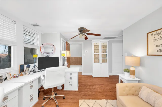 a living room with furniture a flat screen tv and a table