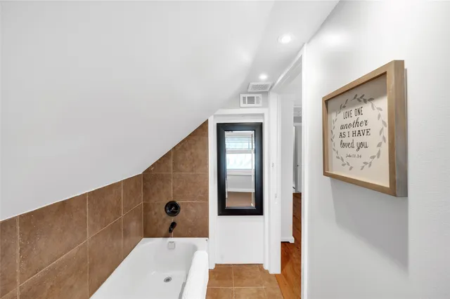 a bathroom with a bathtub and shower
