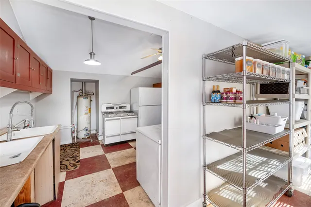 a kitchen with stainless steel appliances kitchen island granite countertop a refrigerator and a stove top oven