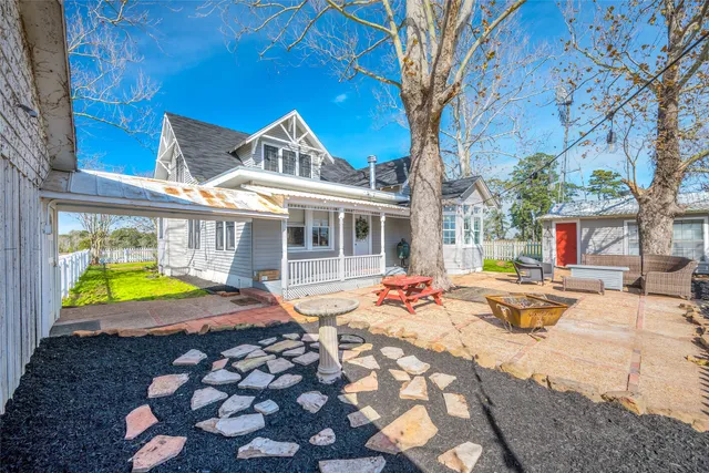 a view of a house with swimming pool and sitting area