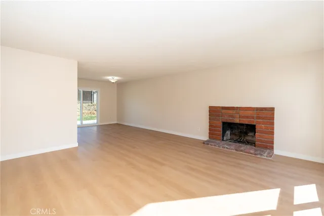 a view of an empty room with a fireplace