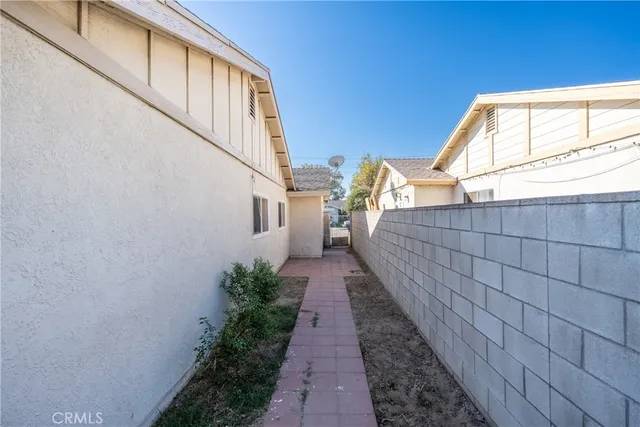a view of a pathway both side of house