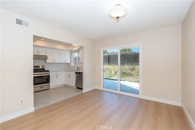 a kitchen with stainless steel appliances a refrigerator and a stove top oven
