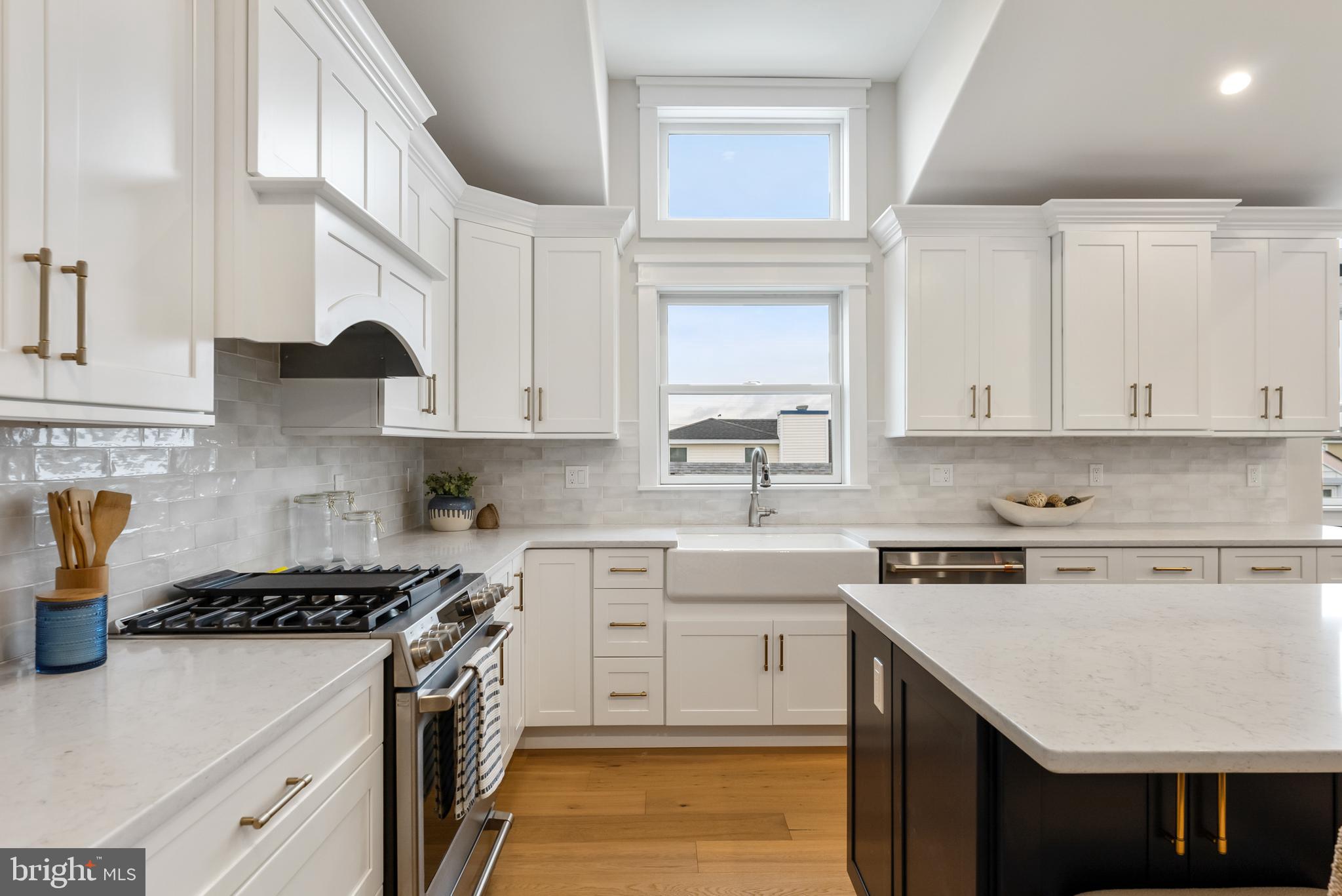16 67th Street Sea Isle City, NJ 08243 - Photo 27 of 40 a kitchen with stainless steel appliances granite countertop a sink stove and cabinets