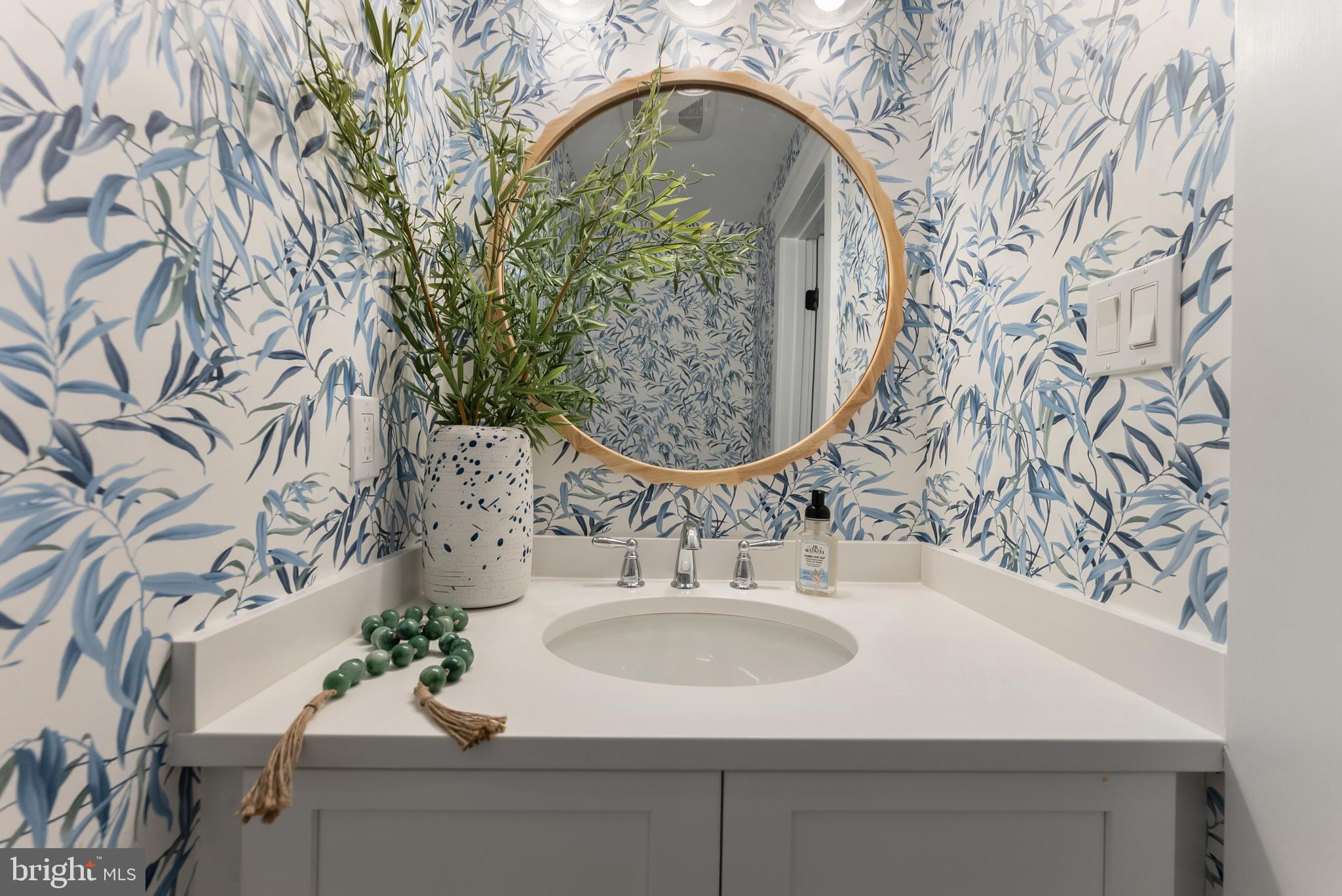 16 67th Street Sea Isle City, NJ 08243 - Photo 31 of 40 a bathroom with a sink and mirror