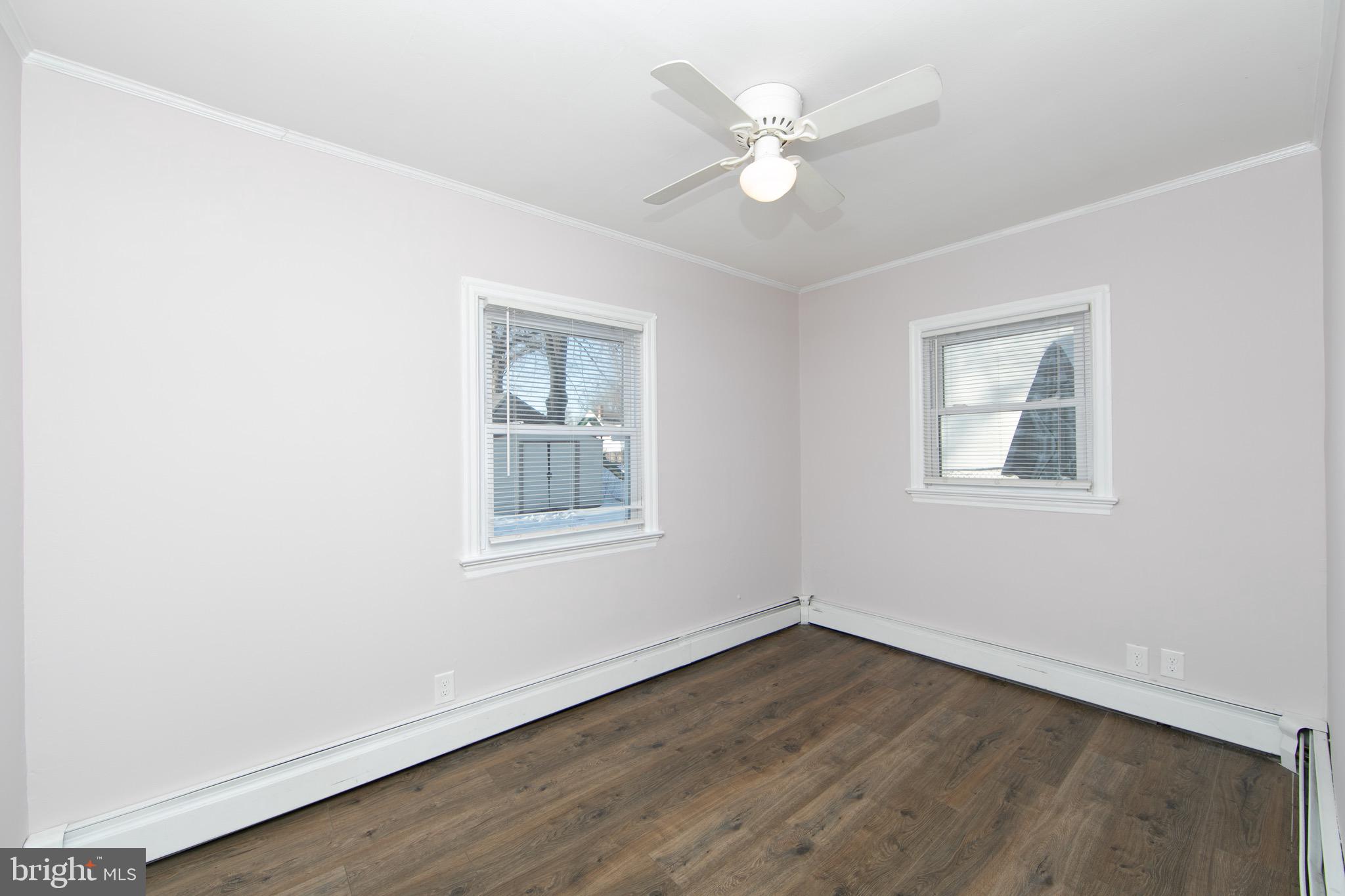 553 Maple Avenue Audubon, NJ 08106 - Photo 16 of 49 an empty room with wooden floor and window