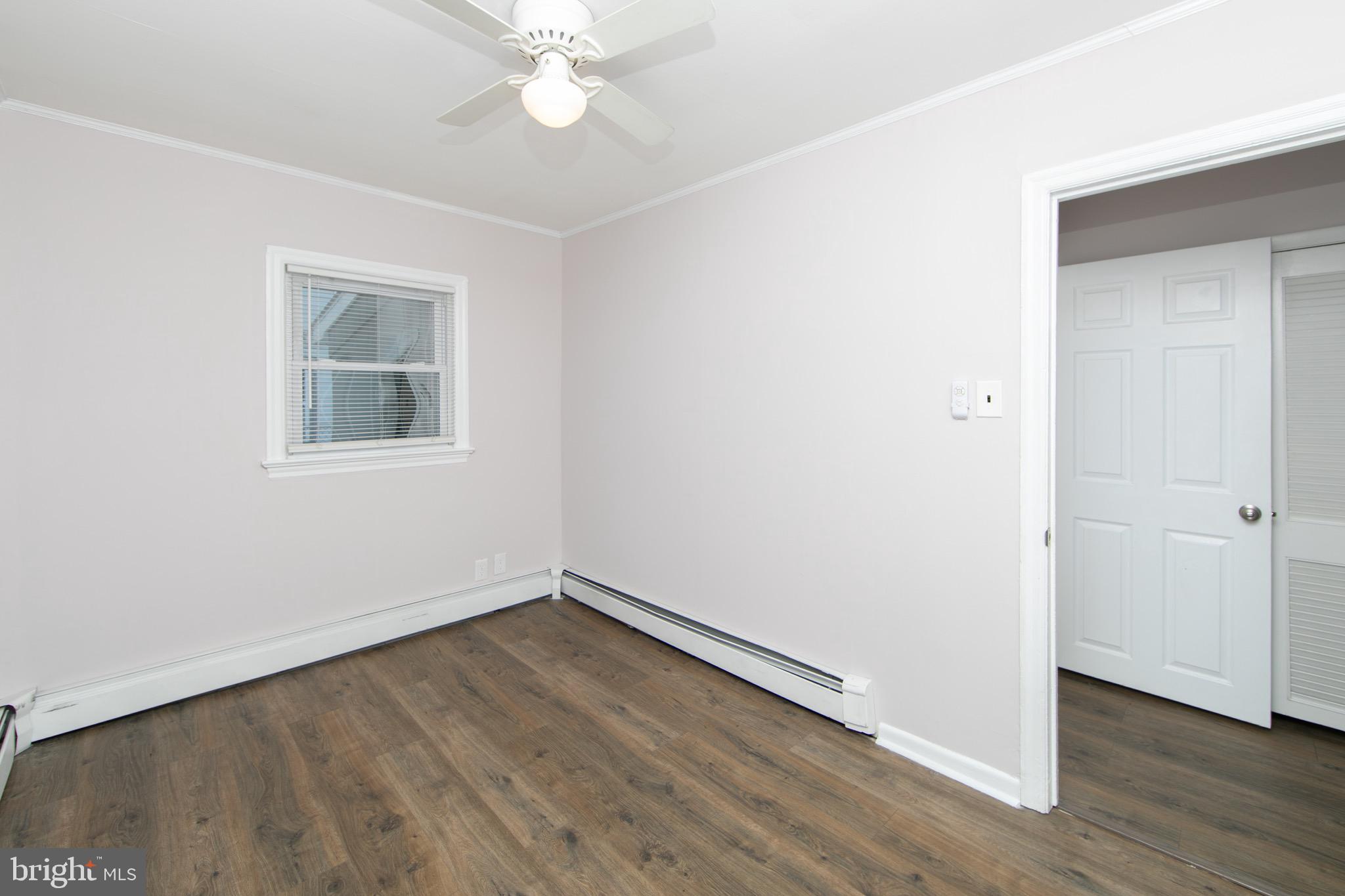 553 Maple Avenue Audubon, NJ 08106 - Photo 17 of 49 an empty room with wooden floor and windows