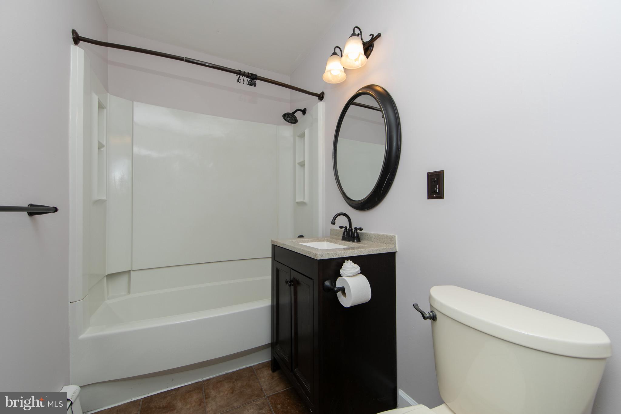 553 Maple Avenue Audubon, NJ 08106 - Photo 19 of 49 a bathroom with a sink a toilet and a mirror
