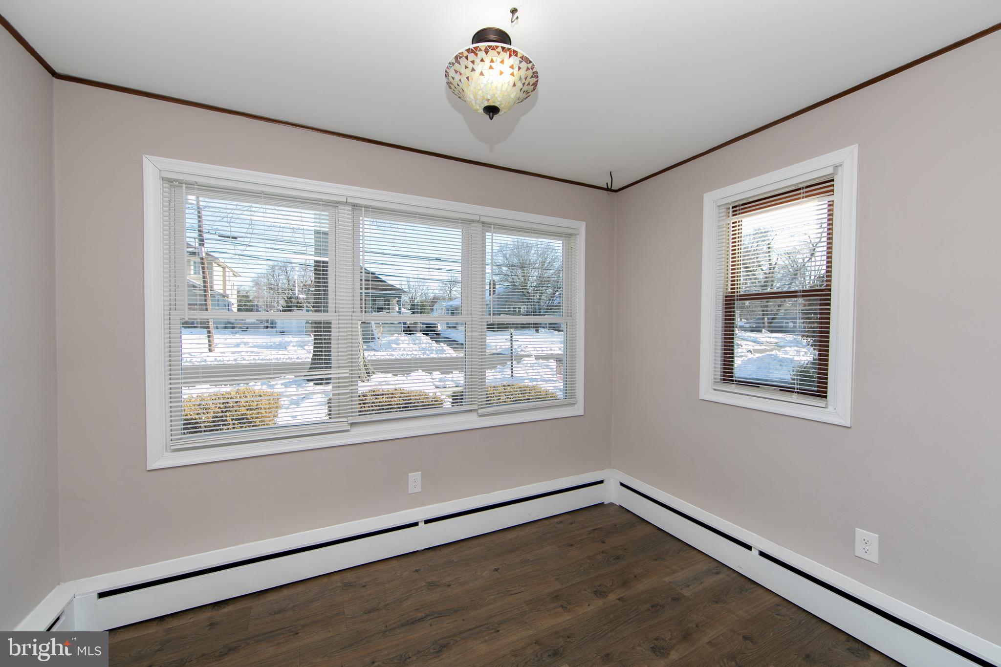553 Maple Avenue Audubon, NJ 08106 - Photo 8 of 49 a view of an empty room with wooden floor and a window