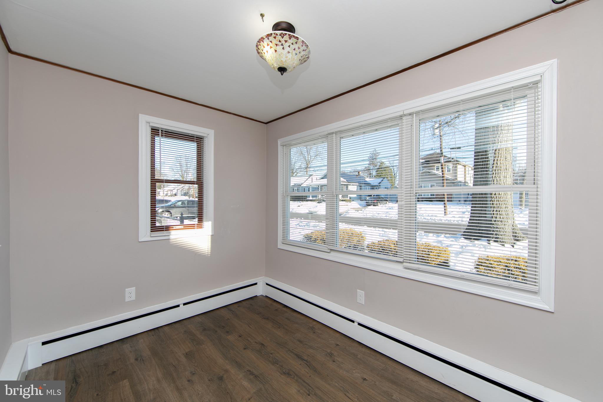 553 Maple Avenue Audubon, NJ 08106 - Photo 9 of 49 an empty room with wooden floor and windows