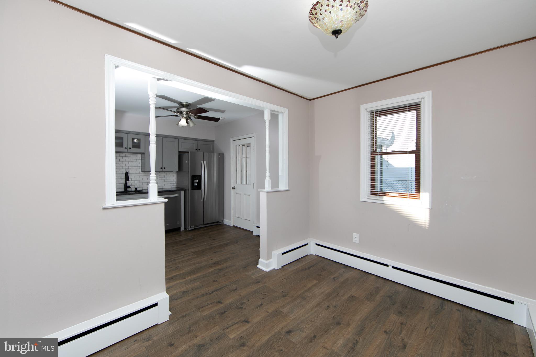 553 Maple Avenue Audubon, NJ 08106 - Photo 10 of 49 an empty room with wooden floor and windows