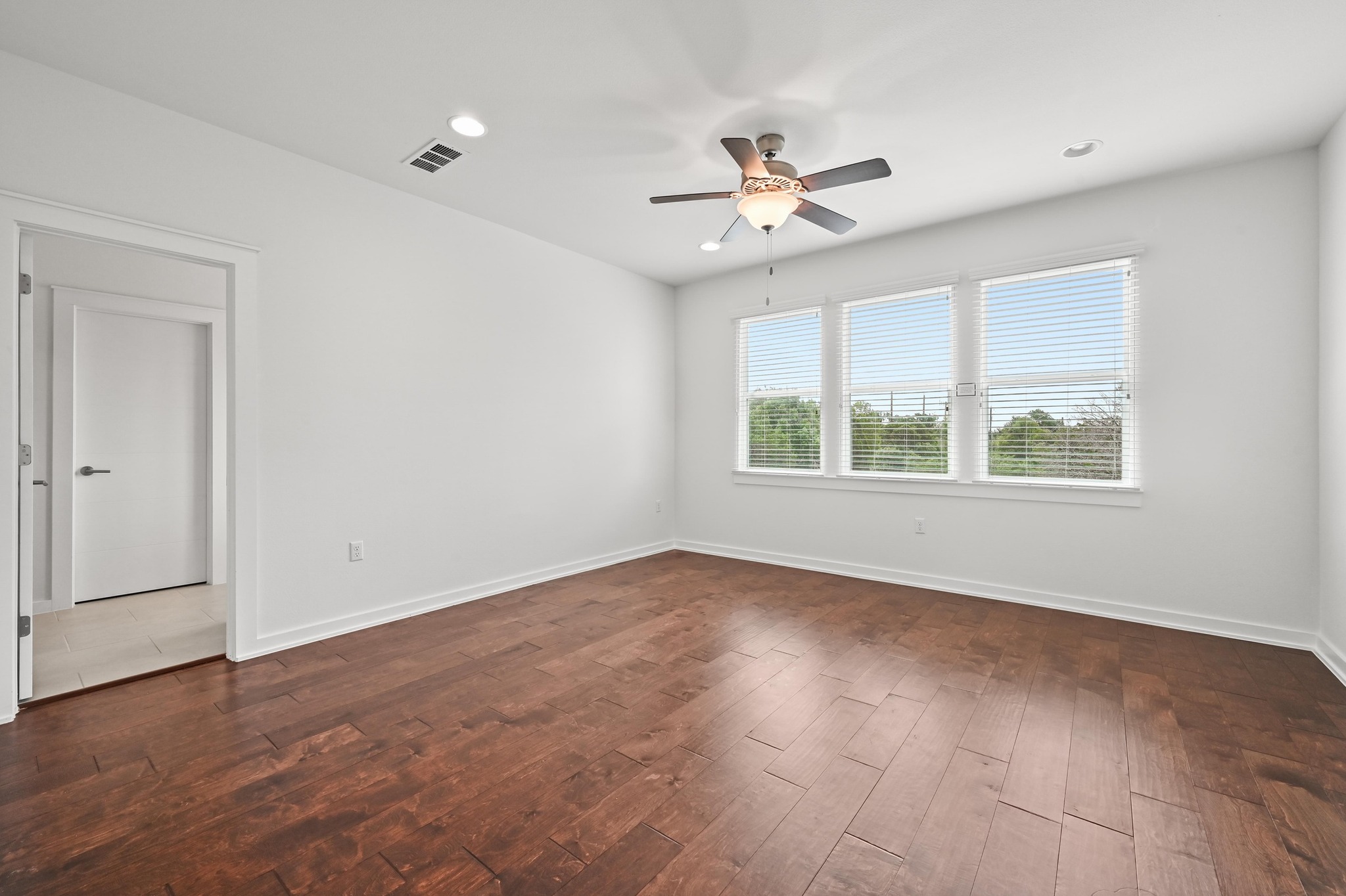 8901 Parker Ranch Circle, Unit A Austin, TX 78748 - Photo 19 of 31 Rich hardwood flooring complements clean walls and abundant natural light from a triple window.