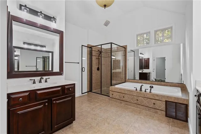 a bathroom with a tub sink and mirror