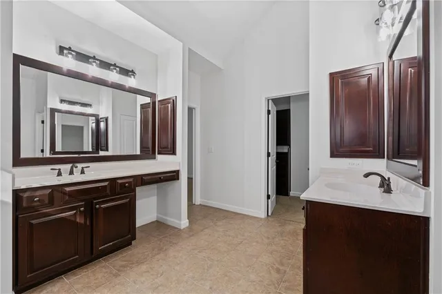 a bathroom with a double vanity sink and mirror