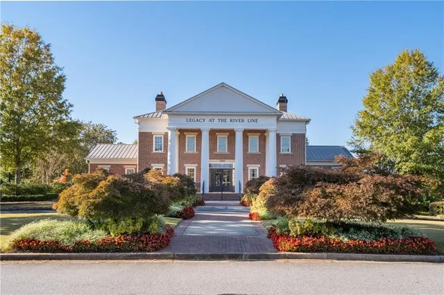 a view of a swimming pool with a lounge chairs in patio