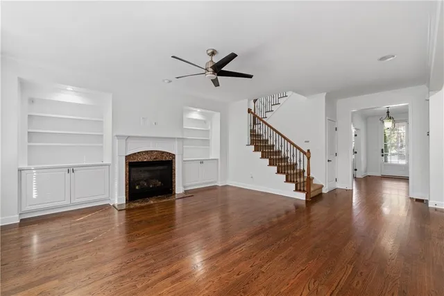 a view of empty room with wooden floor and window