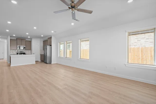 a view of a kitchen with a sink stainless steel appliances and cabinets