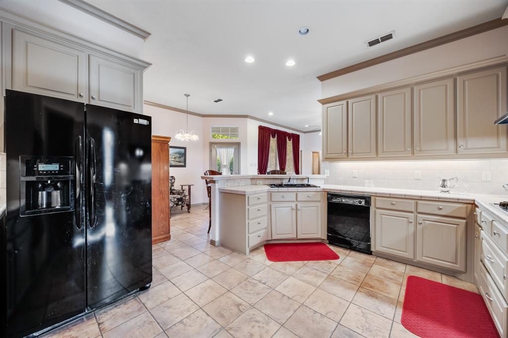 155 Lexington Drive Terrell, TX 75160 - Photo 11 of 27 a kitchen with stainless steel appliances granite countertop a refrigerator sink and stove
