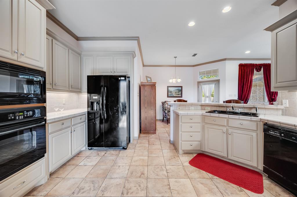 155 Lexington Drive Terrell, TX 75160 - Photo 12 of 27 a kitchen with white cabinets and appliances