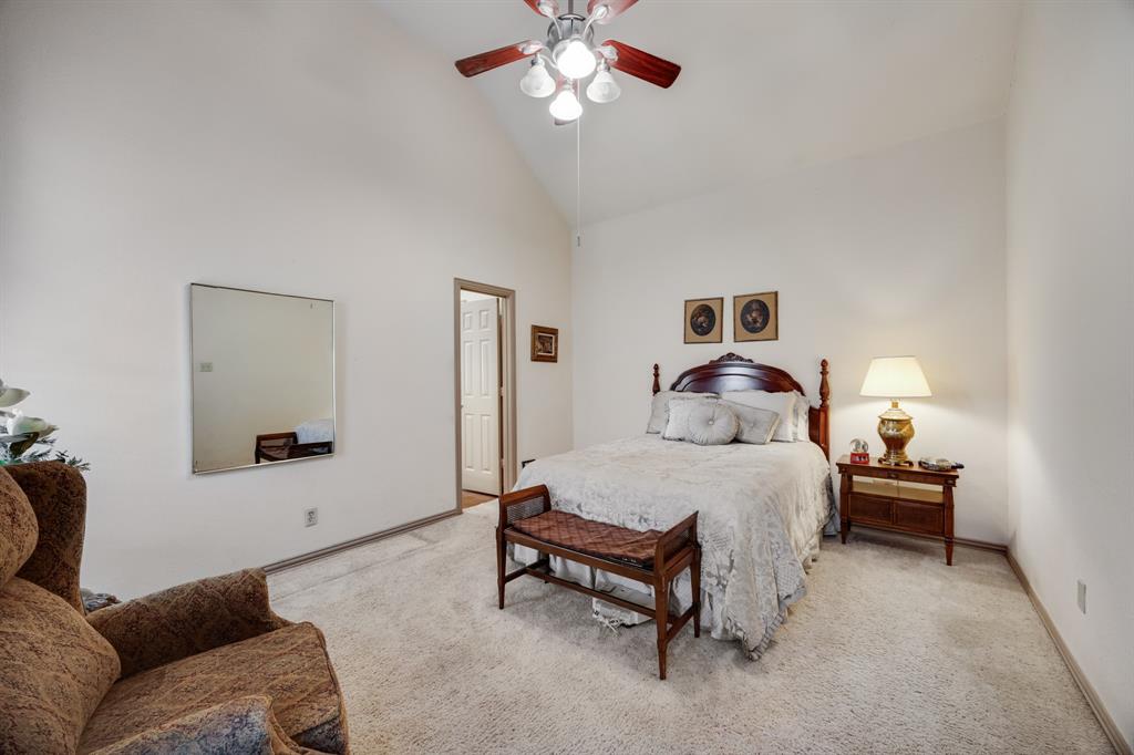 155 Lexington Drive Terrell, TX 75160 - Photo 14 of 27 a bedroom with a bed and a chandelier