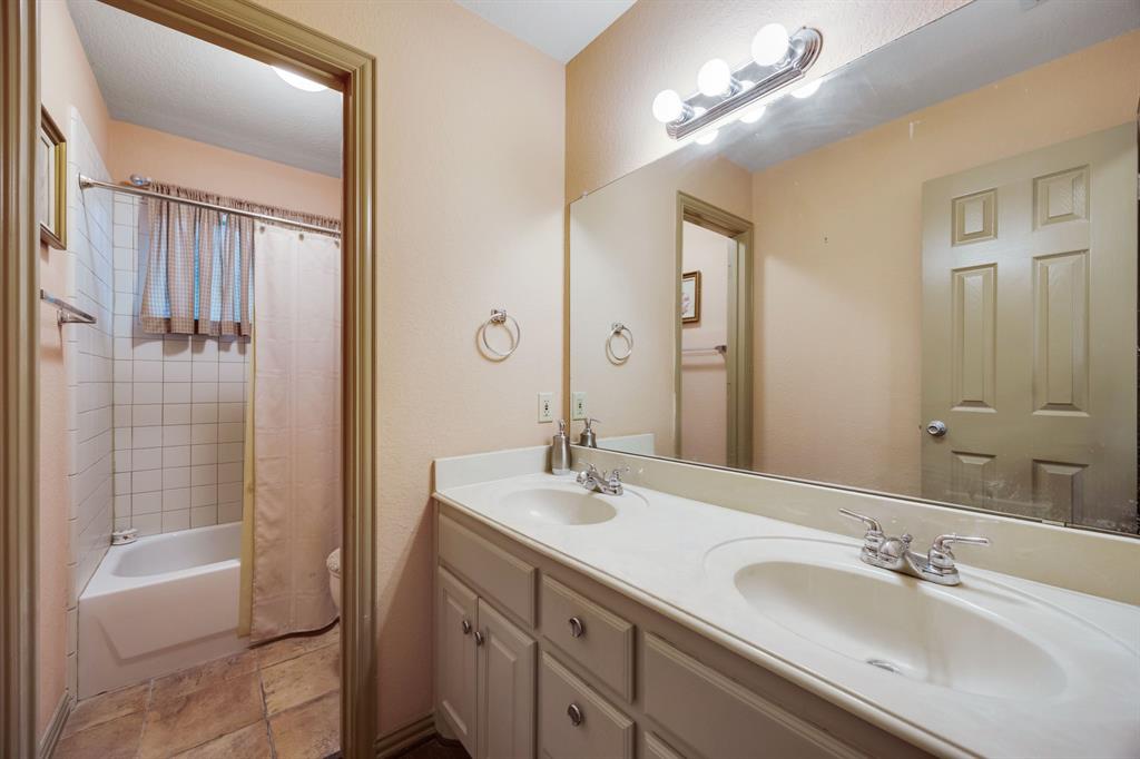155 Lexington Drive Terrell, TX 75160 - Photo 20 of 27 a bathroom with a double vanity sink a shower and a mirror