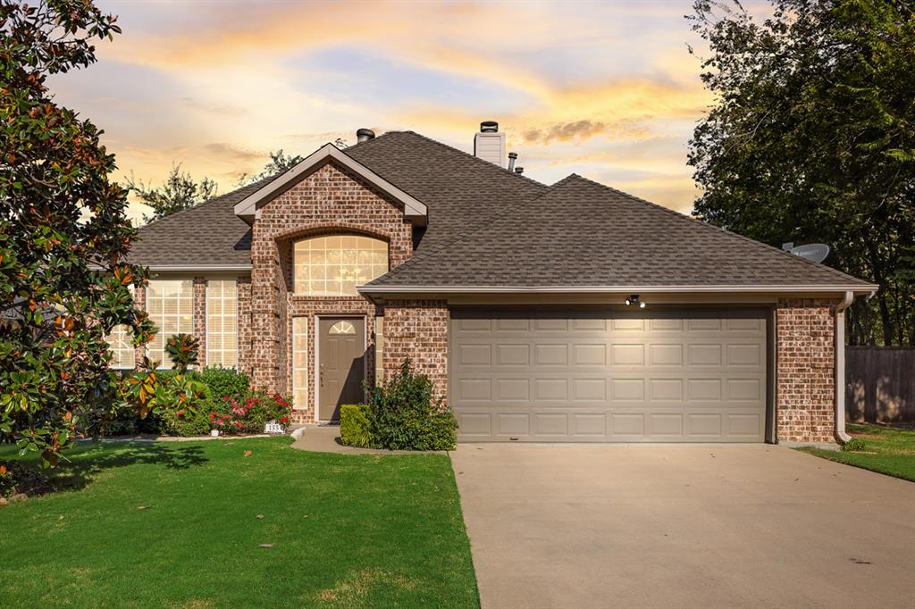 155 Lexington Drive Terrell, TX 75160 - Photo 2 of 27 a front view of white house with a yard and garage