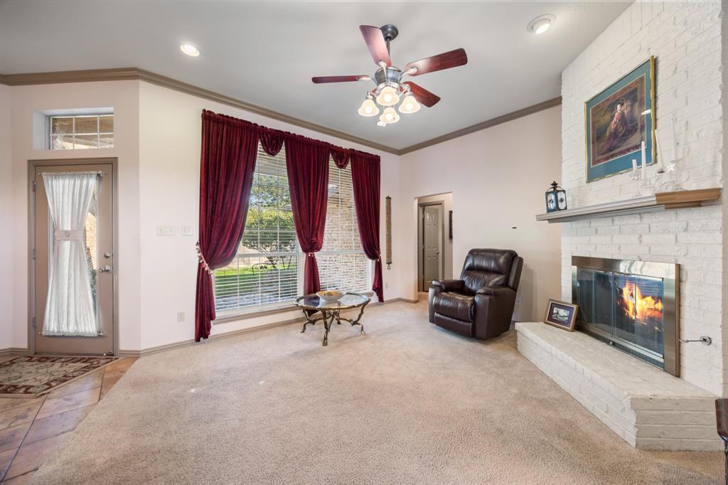 155 Lexington Drive Terrell, TX 75160 - Photo 6 of 27 a living room with furniture and a fireplace