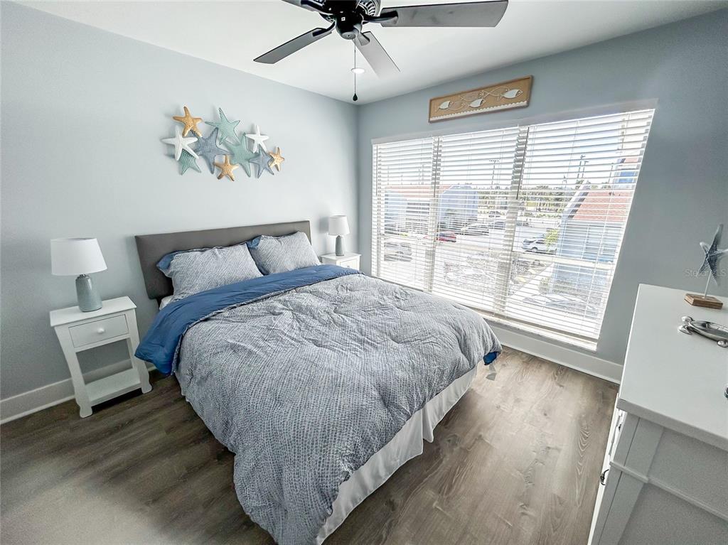 315 Medallion Boulevard, Unit F Madeira Beach, FL 33708 - Photo 11 of 18 a bed sitting in a bedroom next to a window