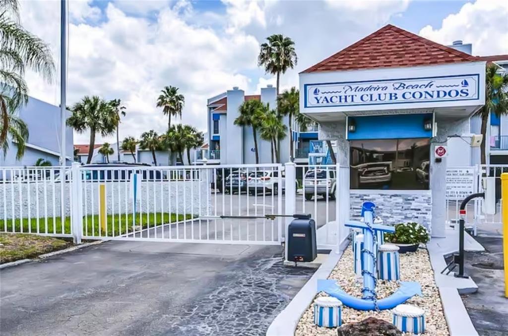 315 Medallion Boulevard, Unit F Madeira Beach, FL 33708 - Photo 14 of 18 a view of a house with potted plants